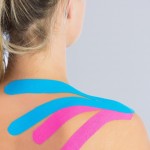 A woman with Kinesio-tape of her shoulder and neck
