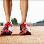 Athletes lower leg in runners standing on a running track