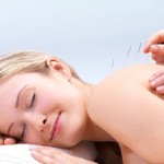 A woman having painful knots released with Dry Needling