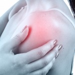 A woman rubbing her painful Shoulder