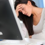 woman at computer suffering from headache